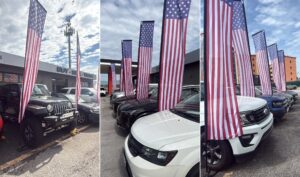 US flag display sets on 4.3 metre poles in front of vehicles on a car dealership lot
