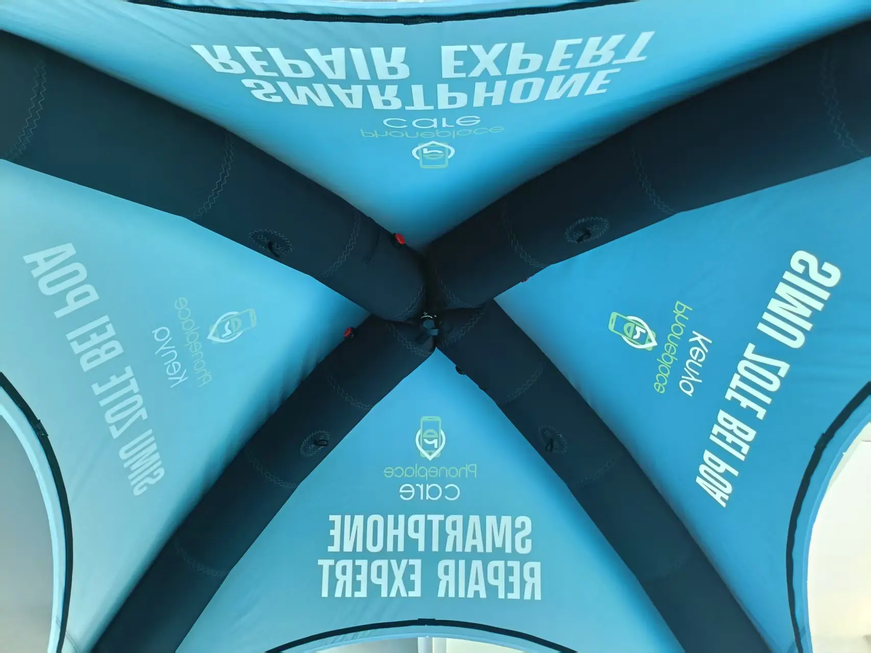 Interior view of advertising tent showing cyan blue branding and roof structure..jpg
