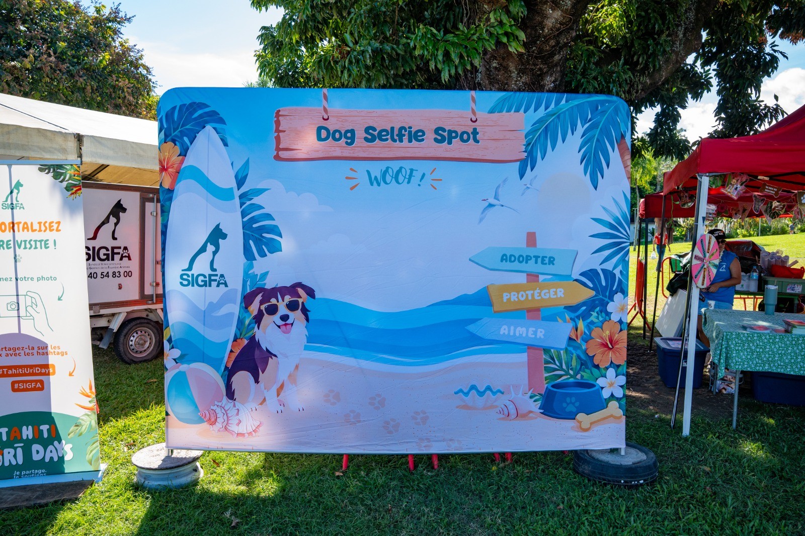 Printed pop-up display backdrop used as a dog selfie wall at an animal adoption event